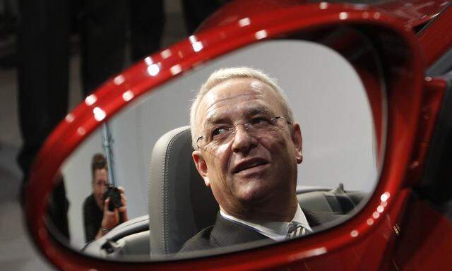 Winterkorn, President and CEO of Porsche Automobil Holding SE poses in Porsche after annual news conference in Stuttgart