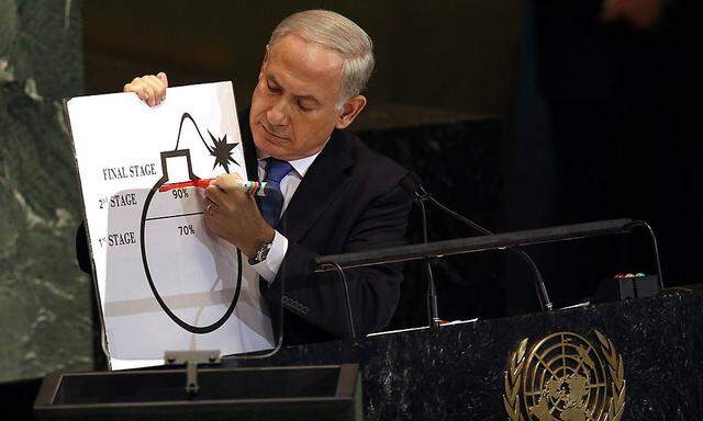 Israeli Prime Minister Benjamin Netanyahu draws a red line on an illustration as he addresses the 67th United Nations General Assembly in New York