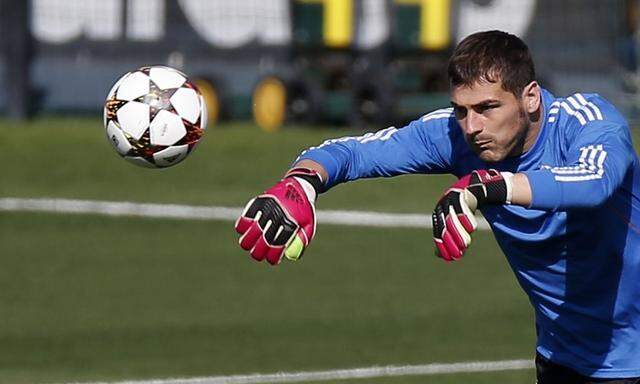 Real Madrid's Casillas throws a ball during their training session on the eve of their Champions League match against Basel in Madrid