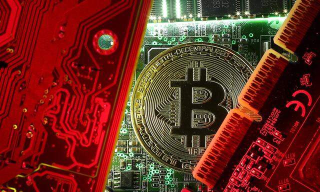 FILE PHOTO: A coin representing the bitcoin cryptocurrency is seen on computer circuit boards in this illustration picture