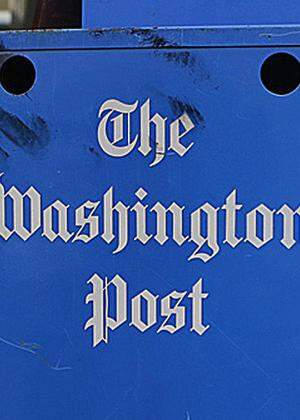 Washington Post and Washington Times newspaper boxes are pictured outside the entrance to the Washington Post headquarters in Washington