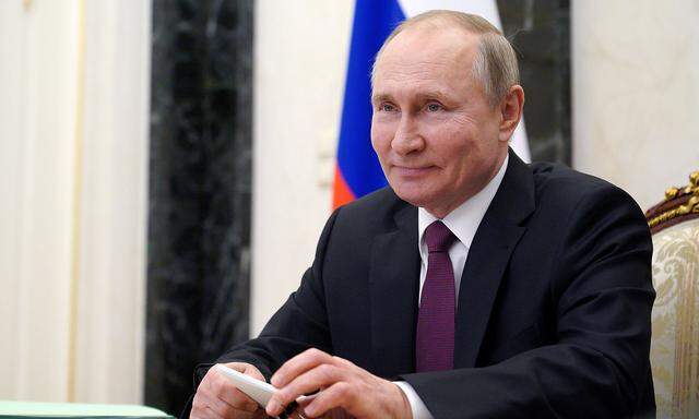 FILE PHOTO: Russian President Vladimir Putin takes part in a video conference call in Moscow