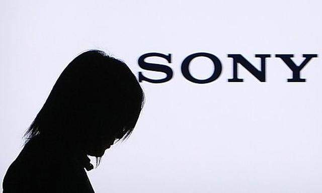 Woman walks past Sony Corp flat TV at the companys headquarters in Tokyos headquarters in Tokyo