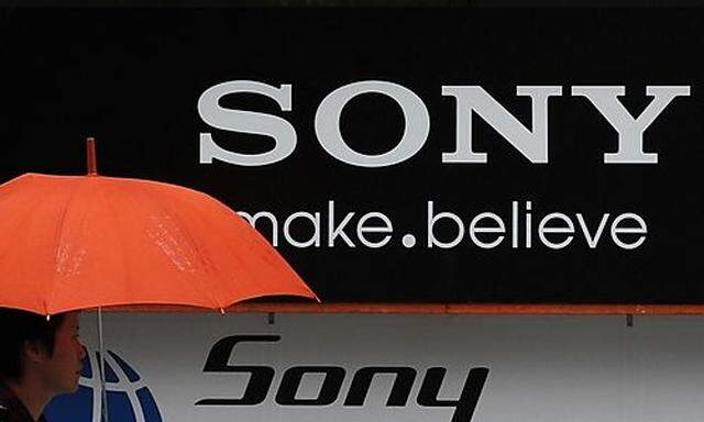 File photograph of man walking past Sony logo in front of  an electronic shop in Tokyo  logo in front of  an electronic shop in Tokyo 