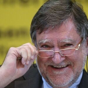 Raiffeisen Bank International CEO Herbert Stepic adjusts his glasses during a news conference in Vienna