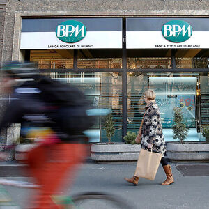 A woman walks in front of the Banca Popolare di Milano (BPM) bank in downtown Milan