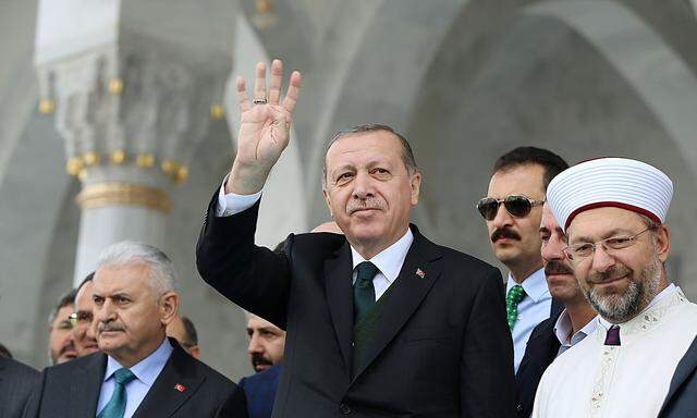 Turkish President Erdogan greets people during the opening ceremony of a mosque in Ankara