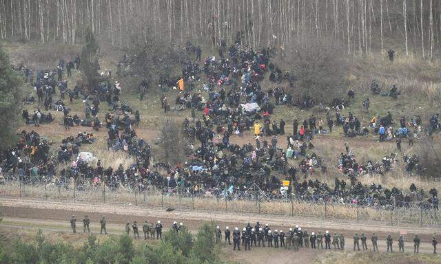 Hundreds of migrants gather at the Belarus side of the border with Poland near Kuznica Bialostocka, Poland, in this photograph released by the Polish Defence Ministry