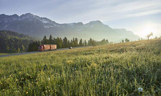 Austria, Tyrol, truck on country road in the morning light