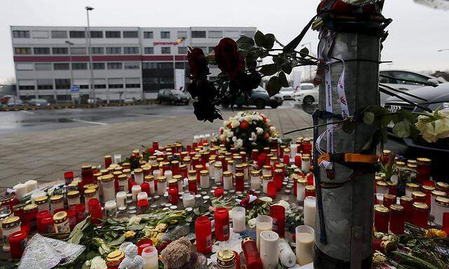 A sea of flowers and candles are placed on the ground outside the Germanwings headquarters at Cologne-Bonn airport 