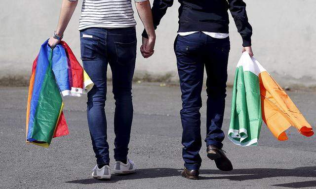 A couple walks hand in hand from the count centre in Dublin as Ireland holds a referendum on gay marriage
