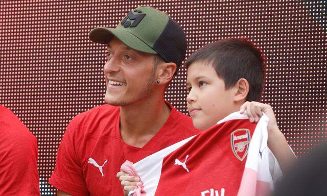 Arsenal's Mesut Ozil of Germany attends a meet and greet session with fans in Singapore