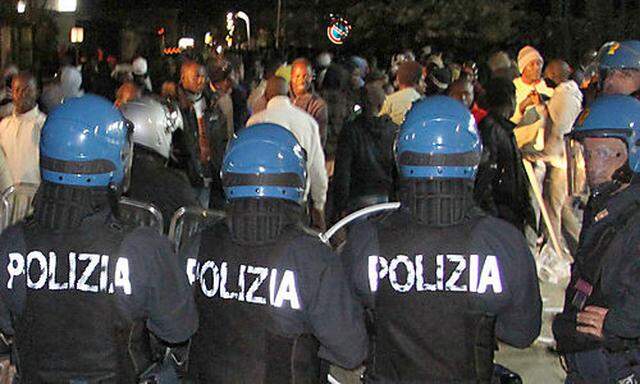 In this photo taken Jan. 7, 2010 made available Friday Jan. 8 2010, Italian police officers in riot g