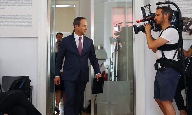 Head of NEOS party Strolz arrives for a news conference in Vienna
