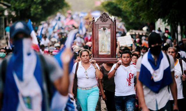 People take part in a march in support of the Catholic Church in Leon