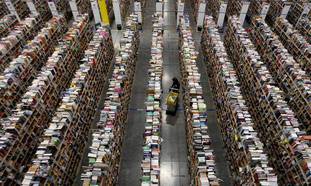 FILE PHOTO: A Worker gathers items for delivery at Amazon's distribution center in Phoenix