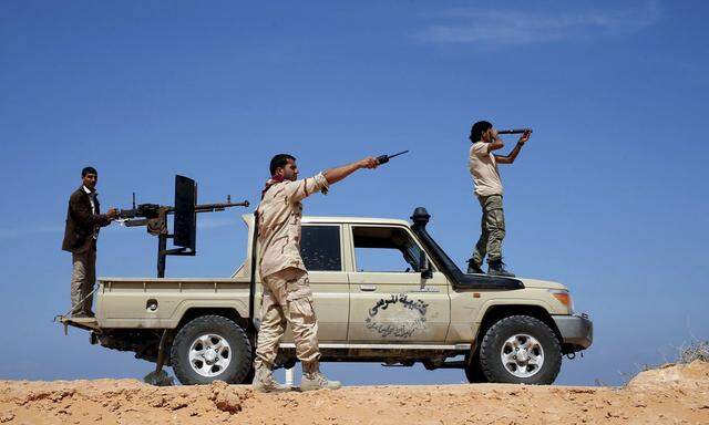 Libya Dawn fighters look at Islamic State militant positions near Sirte