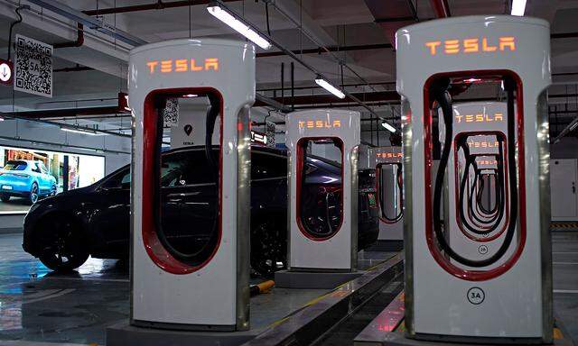 Tesla Superchargers are pictured in a parking lot in Suzhou