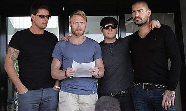 Members of Boyzone, from left, Keith Duffy, Ronan Keating, Mikey Graham and Shane Lynch make a statem