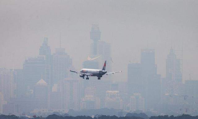 An Australian commercial aircraft prepares to land in the haze at Sydney´s International Airport