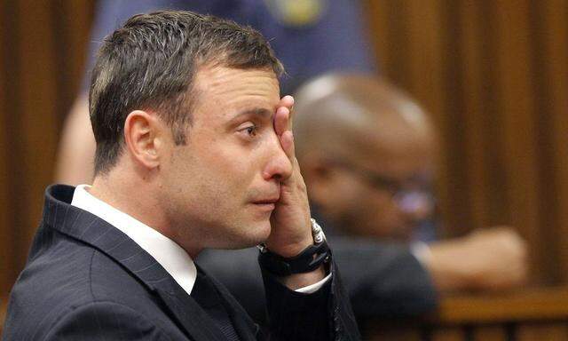 Olympic and Paralympic track star Pistorius reacts as he listens to Judge Masipa's judgement at the North Gauteng High Court in Pretoria