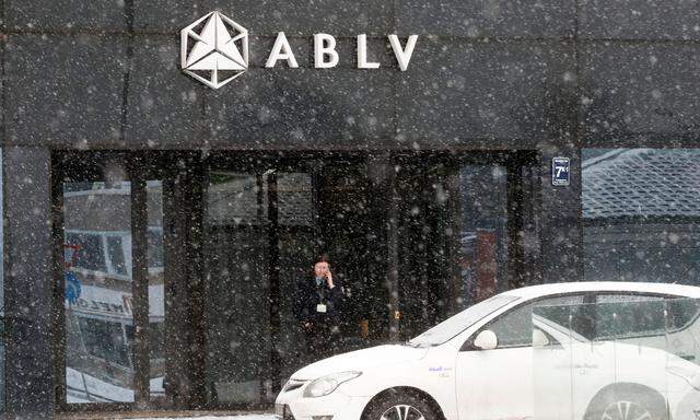 FILE PHOTO: A security guard speaks on her mobile phone at the head office of the ABLV Bank