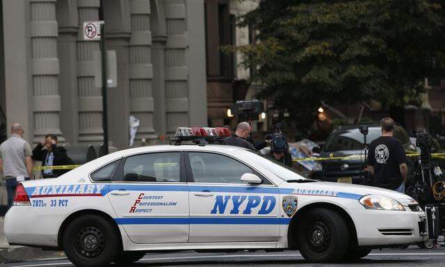 A NYPD vehicle blocks West 75th street outside an apartment building where two children died in a stabbing, on New York City's upper west side of Manhattan