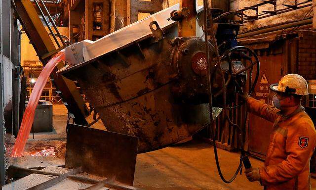 A worker operates a mixer of fused aluminium at the foundry shop of the Rusal Krasnoyarsk aluminium smelter in Krasnoyarsk