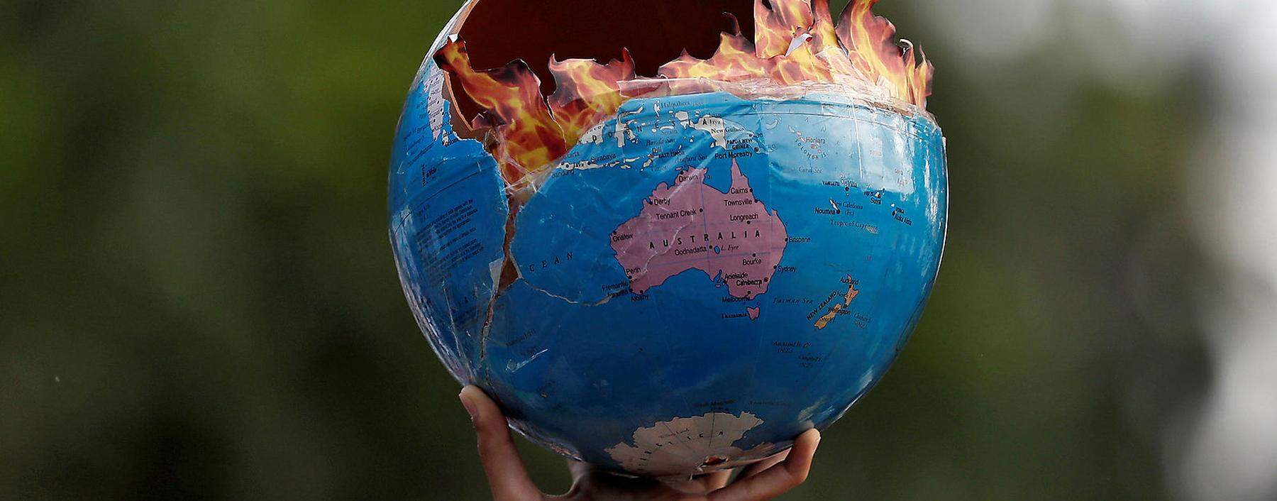 A participant holds a replica depicting globe on fire during a ´Fridays for Future´ march calling for urgent measures to combat climate change, in Mumbai