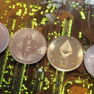 FILE PHOTO: FILE PHOTO: Representations of the Ripple, Bitcoin, Etherum and Litecoin virtual currencies are seen on motherboard in this illustration picture