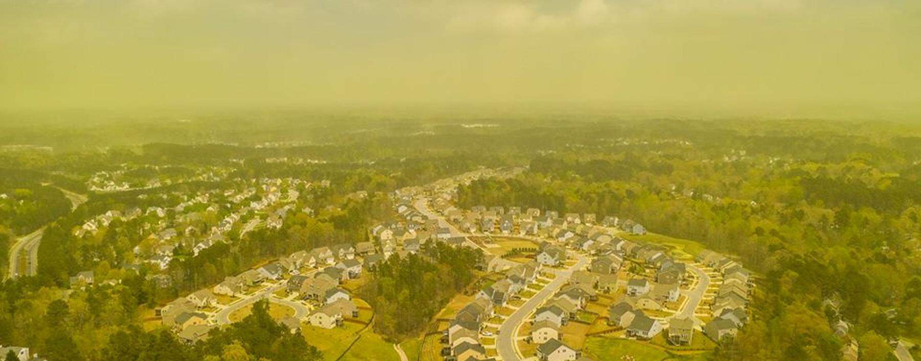 An aerial view shows pollen haze tinting the environment yellow over an area in Durham, North Carolina