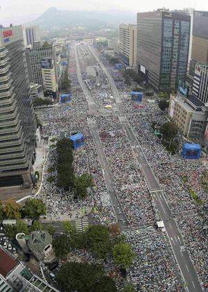 Catholic faithful gather to watch a Holy Mass led by Pope Francis at Gwanghwamun square in Seoul