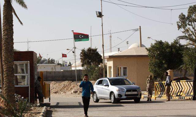 A passenger walks at the security checkpoint at the Ras Jdir border