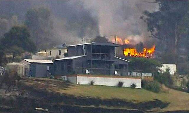 Still image taken from video shows a house on fire in the Tasmanian town of Dunalley