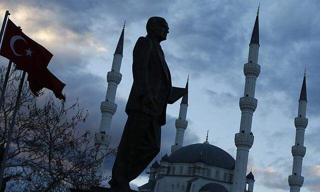 A statue of modern Turkey´s founder Ataturk and a mosque in the background are pictured in a square where Turkish Prime Minister Erdogan is to attend an election rally of his of ruling AK Party (AKP) in Kirikkale, central Turkey