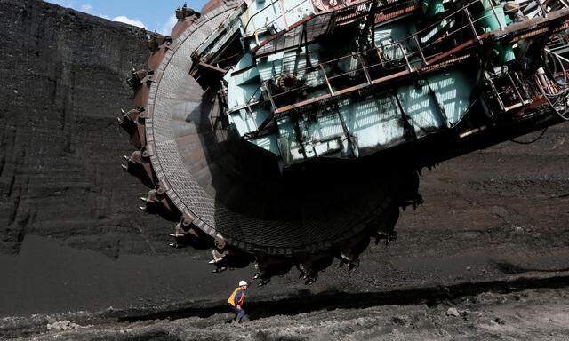 A worker examines a Soviet-made rotary dredge before operations at the Beryozovsky opencast colliery, owned by SUEK, in Krasnoyarsk region