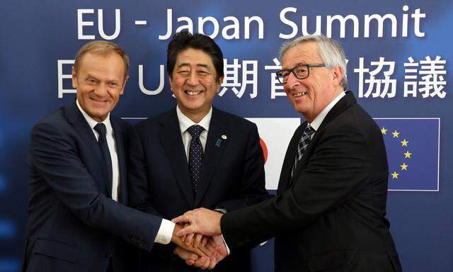 Japan's PM Abe is welcomed by EU Council President Tusk and EC President Juncker at the start of a EU-Japan summit in Brussels