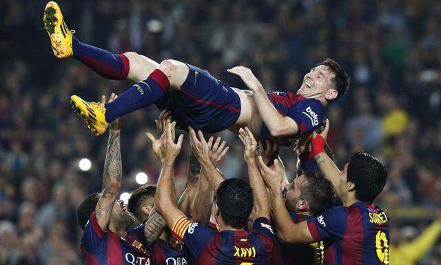 Barcelona's Messi celebrates his second goal with teammates during their Spanish first division soccer match against Sevilla at Nou Camp stadium in Barcelona