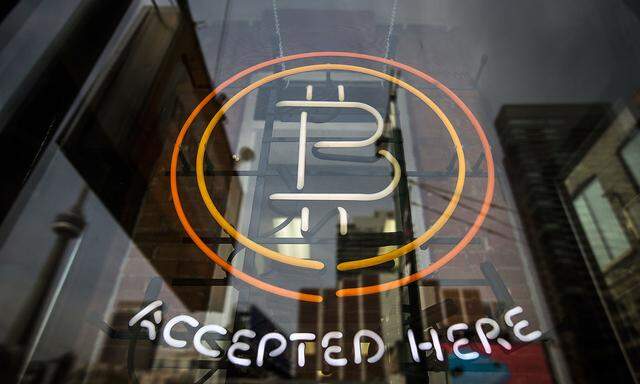 A Bitcoin sign is seen in a window in Toronto