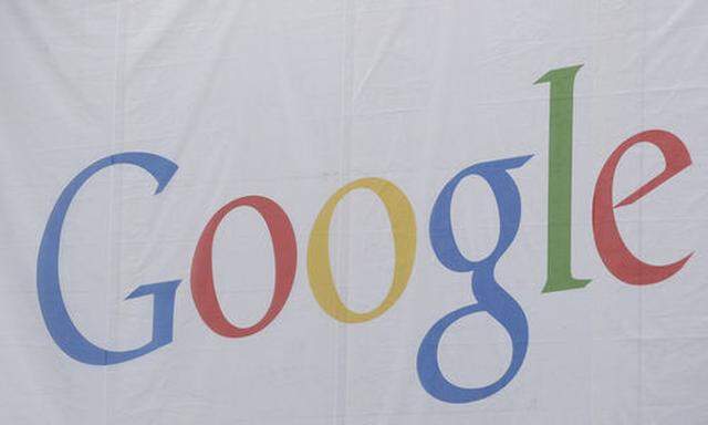 Workmen hang a giant advertising banner for Google Internet search company on a building facade in At