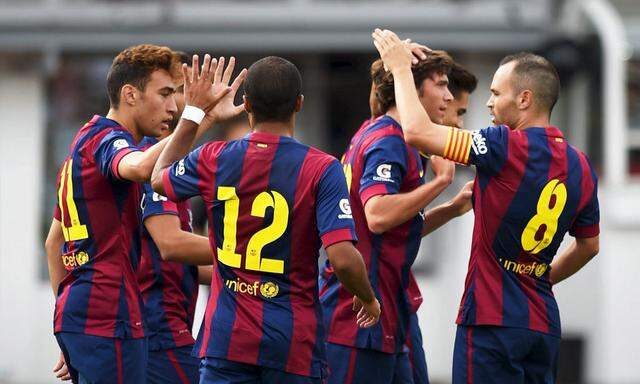 Barcelona's players celebrating a goal against HJK during their friendly soccer match in Helsinki