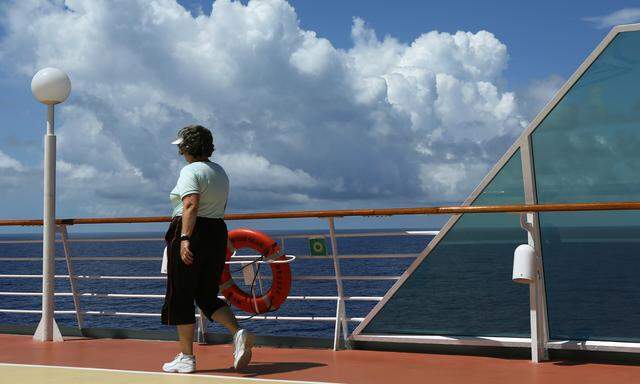 Woman walks on the top deck aboard the Royal Caribbean Grandeur of the Seas en route to Bermuda