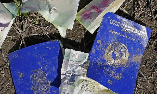 Damaged service passport of the Republic of Guinea is seen lying on the ground on the path migrants walked to cross the border into Croatia, near Sid