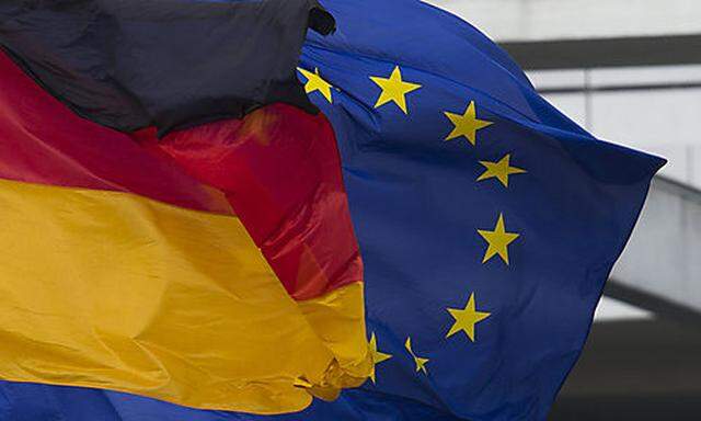 A European, right, and a German flag fly in the wind at the Place of the Republic in Berlin, Thursday