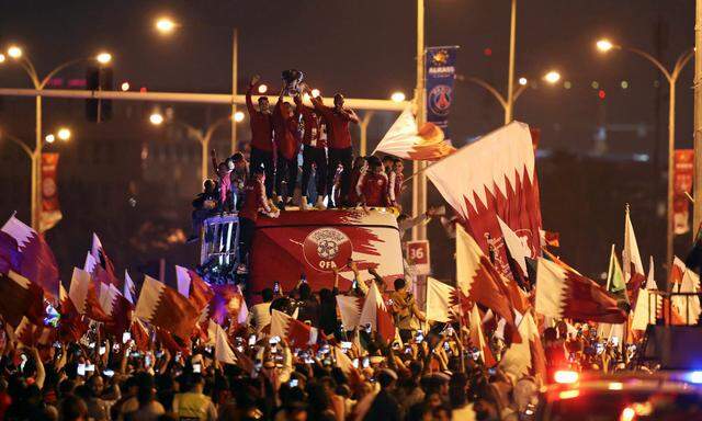 Qatar players celebrate with the trophy after winning the Asian Cup in Doha