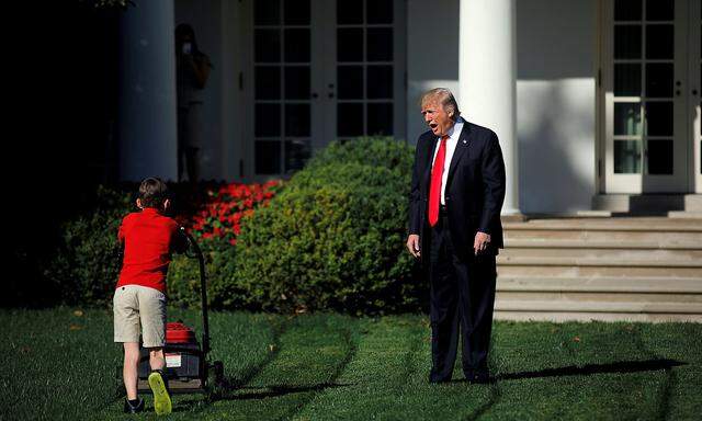U.S. President Donald Trump welcomes 11-years-old Frank Giaccio as he cuts the Rose Garden grass at the White House in Washington