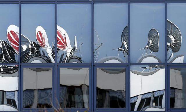 Satellitenschüsseln spiegeln sich in den Fenstern eines deutschen Medienhauses. Dessen Aktie könnte heuer noch von sich reden machen.