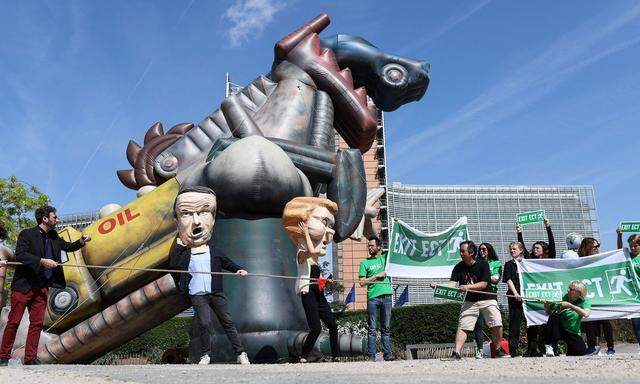 Umweltaktivisten, die Masken tragen, imitieren EU-Kommissionspräsidentin Ursula von der Leyen und Frankreichs Präsident Emmanuel Macron