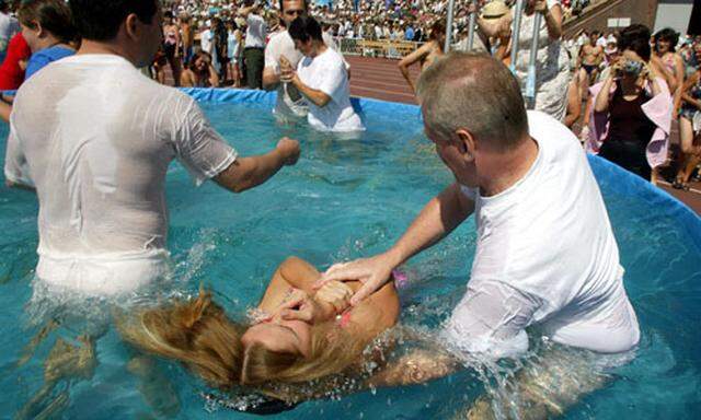 New members of the religion organisation Jehovahs Witnesses are baptized in Kievs Olympic stadium