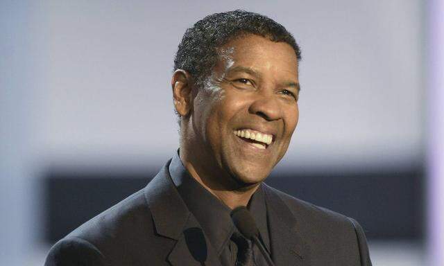 U.S. actor Denzel Washington receives a Donostia award for his film career from director Antoine Fuqua on the first day of the 62nd San Sebastian Film Festival